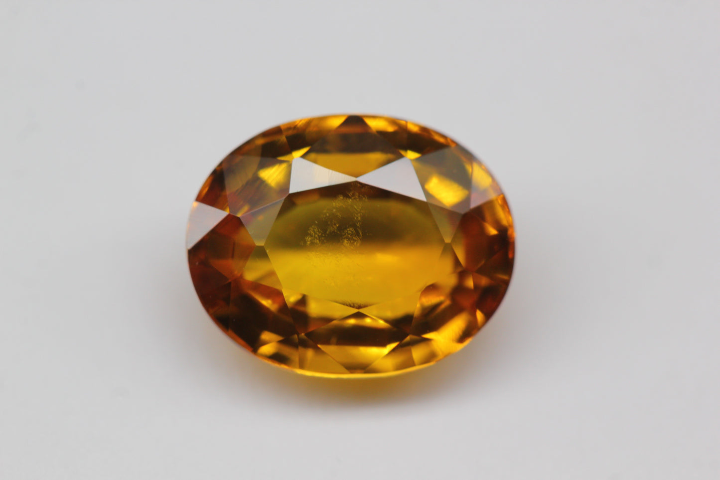 (SOLD) 10x8mm Oval Orange-Yellow Sapphire (SAYV1012)